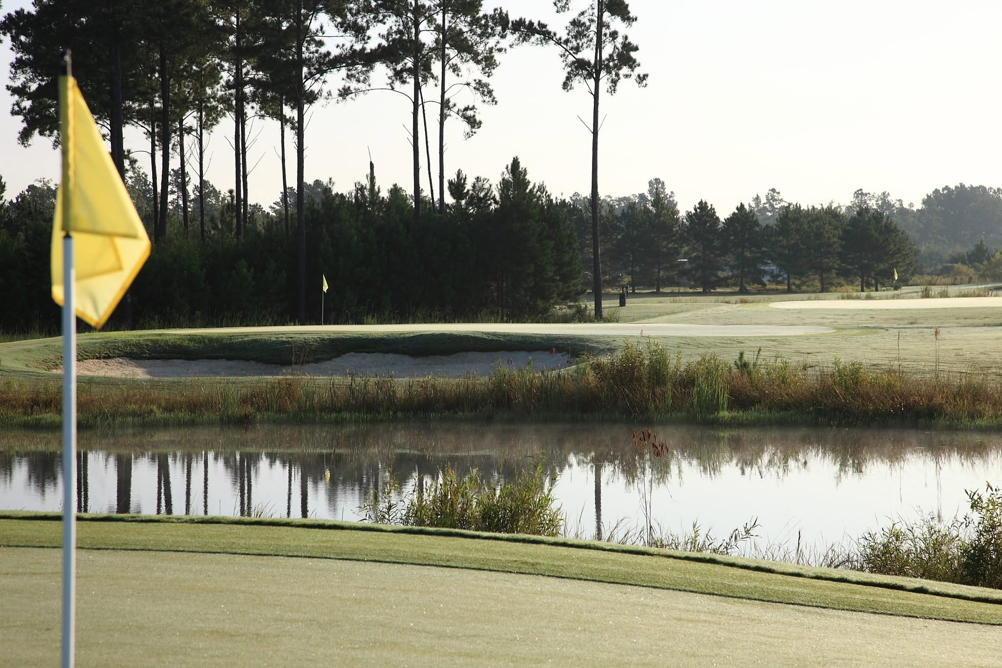 Morning light over a green and water hazard at The Golf Club at Hilton Head Lakes