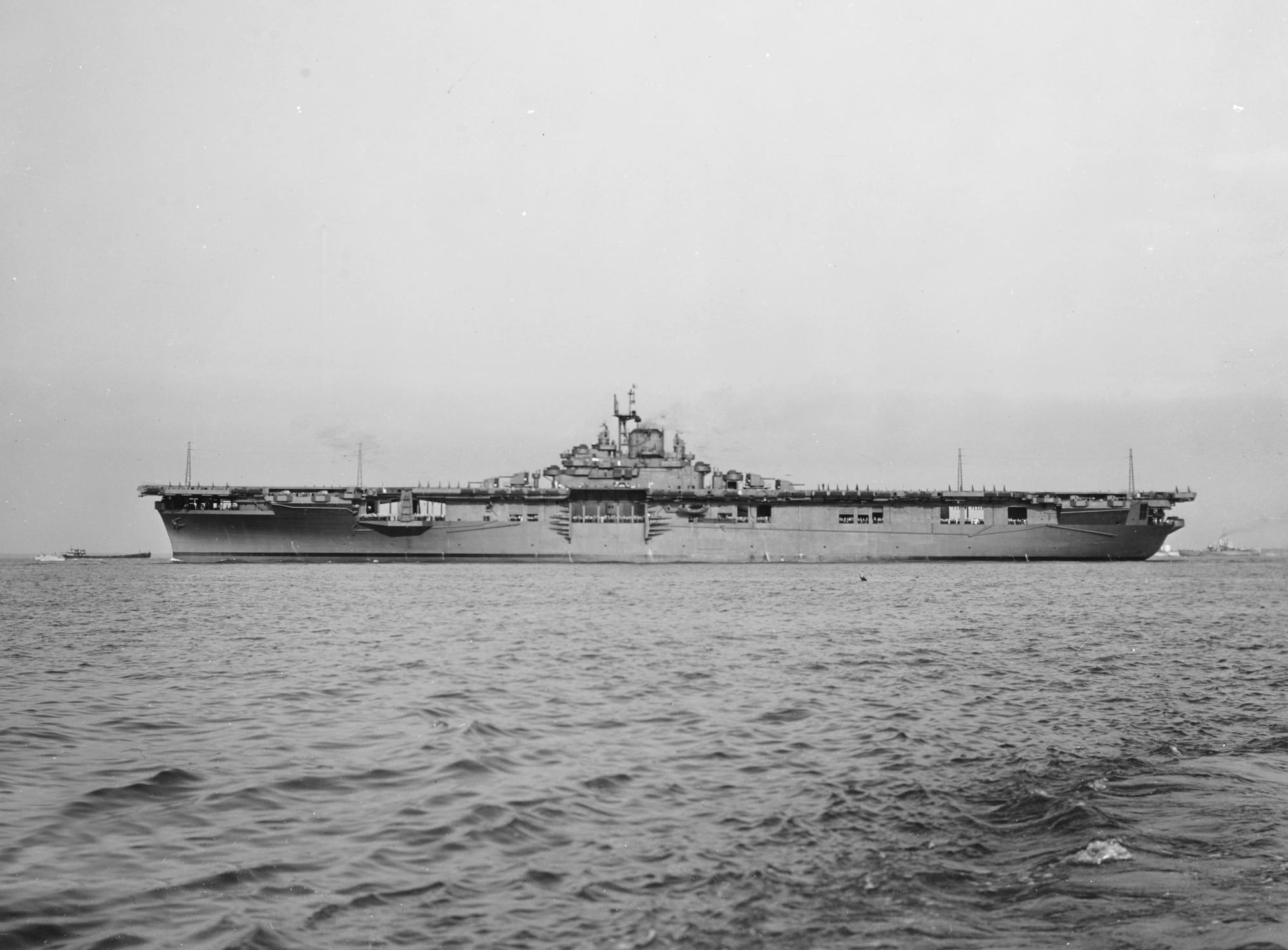 USS Intrepid underway off Newport News, Virginia, in August 1943, photographed broadside in calm water